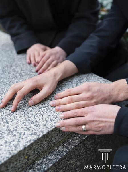  Cappella Gentilizia Milano: Famiglia che appoggia le mani su una lapida